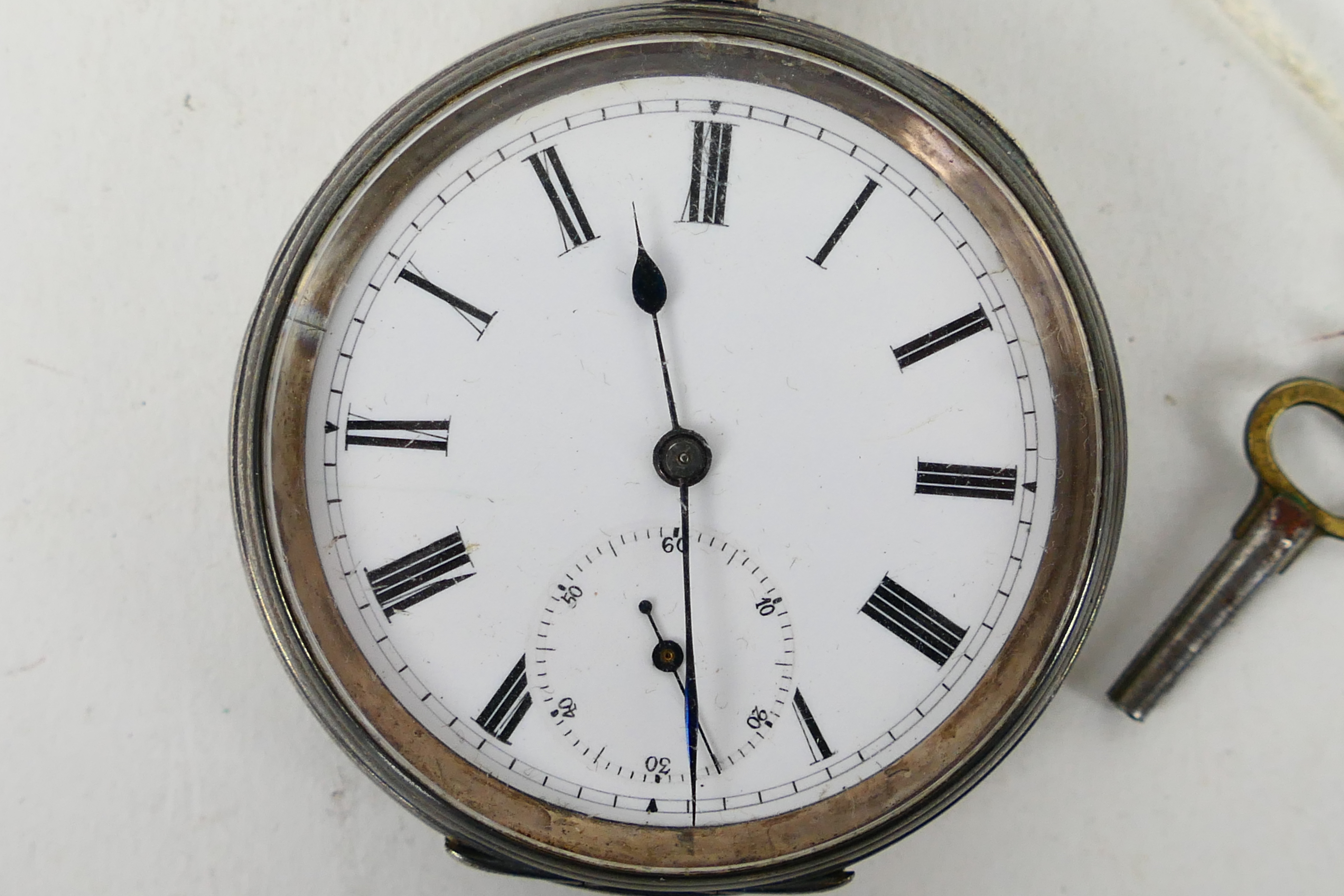 A Swiss silver (935 fineness) cased open face pocket watch, Roman numerals to a white enamel dial, - Image 2 of 6