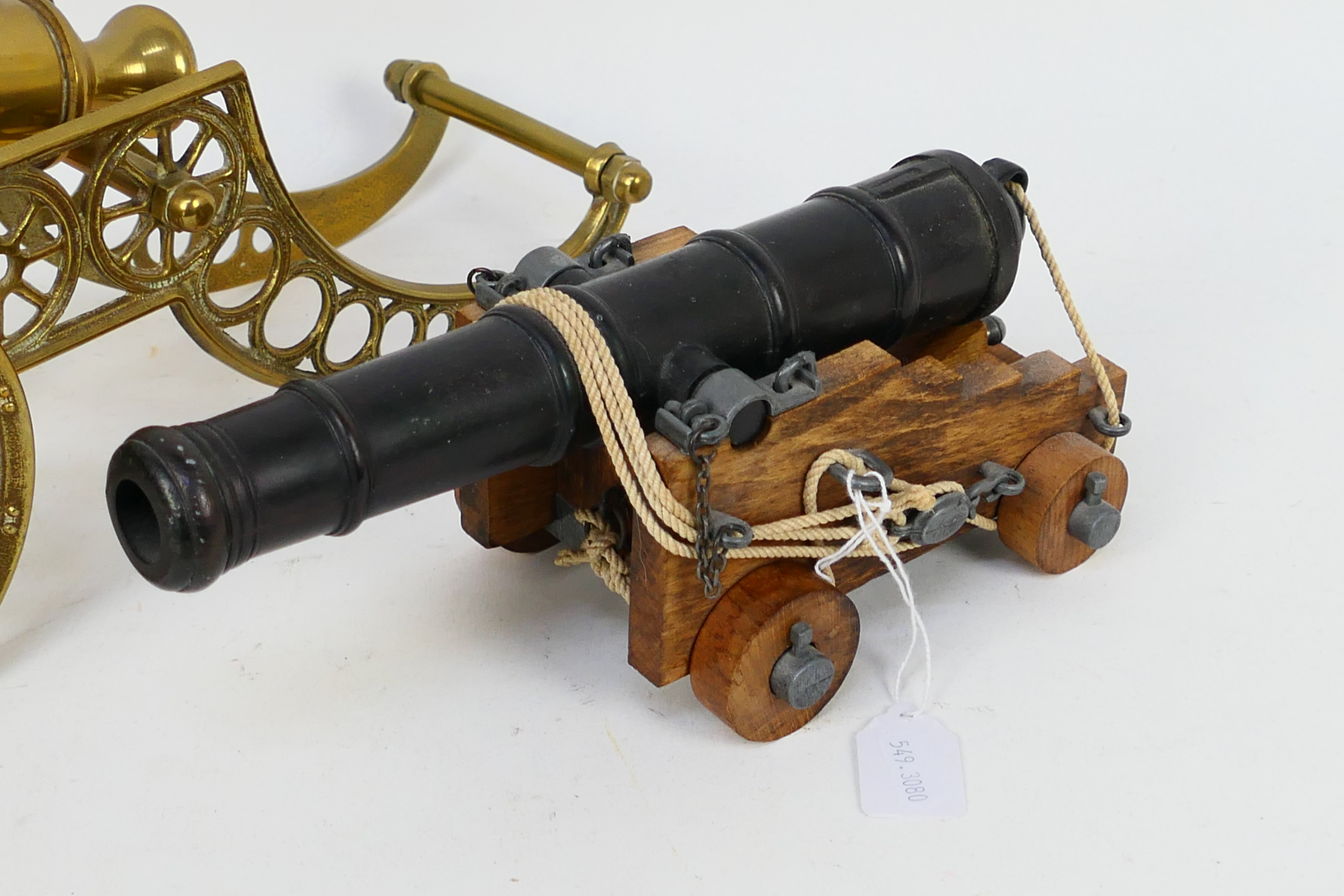 A model canon on wooden carriage and a brass example, largest 42 cm (l). [2]. - Image 2 of 3