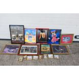 A collection of framed prints, posters and similar, varying image sizes.