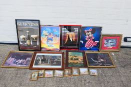 A collection of framed prints, posters and similar, varying image sizes.