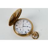 A gold plated full hunter pocket watch, Roman numerals to a white enamel dial,