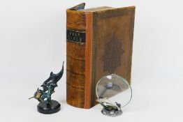 A Victorian family bible, cast metal model of dolphins on circular marble base,