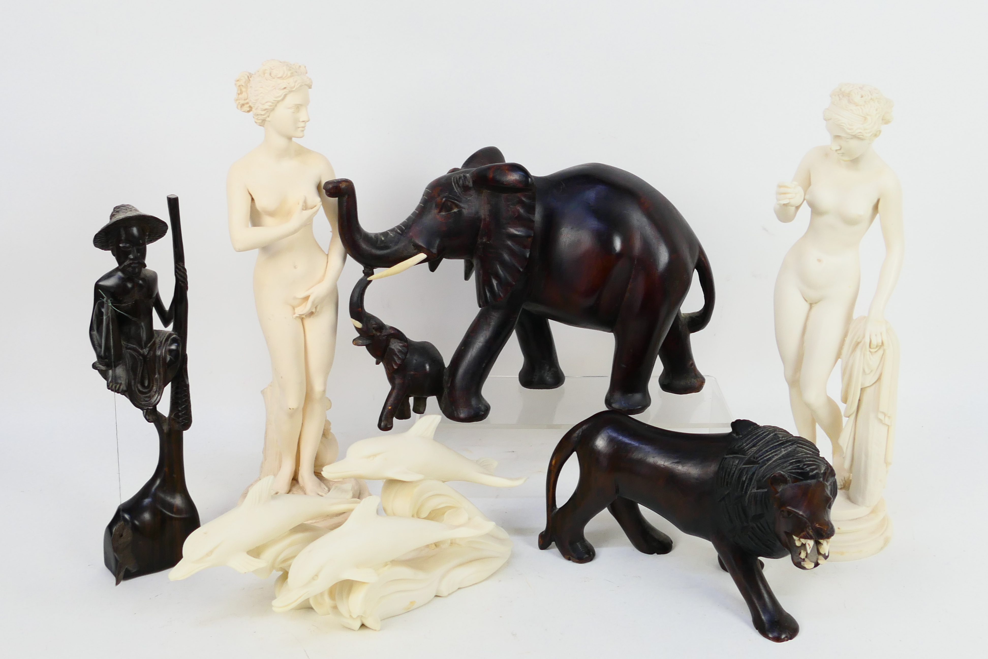 Lot to include wooden carvings comprising elephant, lion and other,