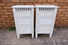 A pair of white vintage style wooden bedside cabinets,