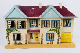 A wooden doll's house with applied floral decals,