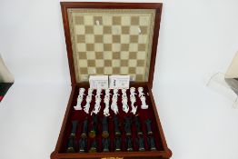 A Franklin Mint chess set, The Chess Set Of The Gods by Stuart Mark Feldman,