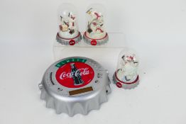 Three Coca Cola polar bear groups housed under glass domes, approximately 12.