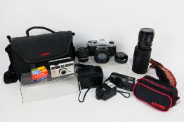 Photography - A Pentax K1000 camera with additional lenses and soft case,
