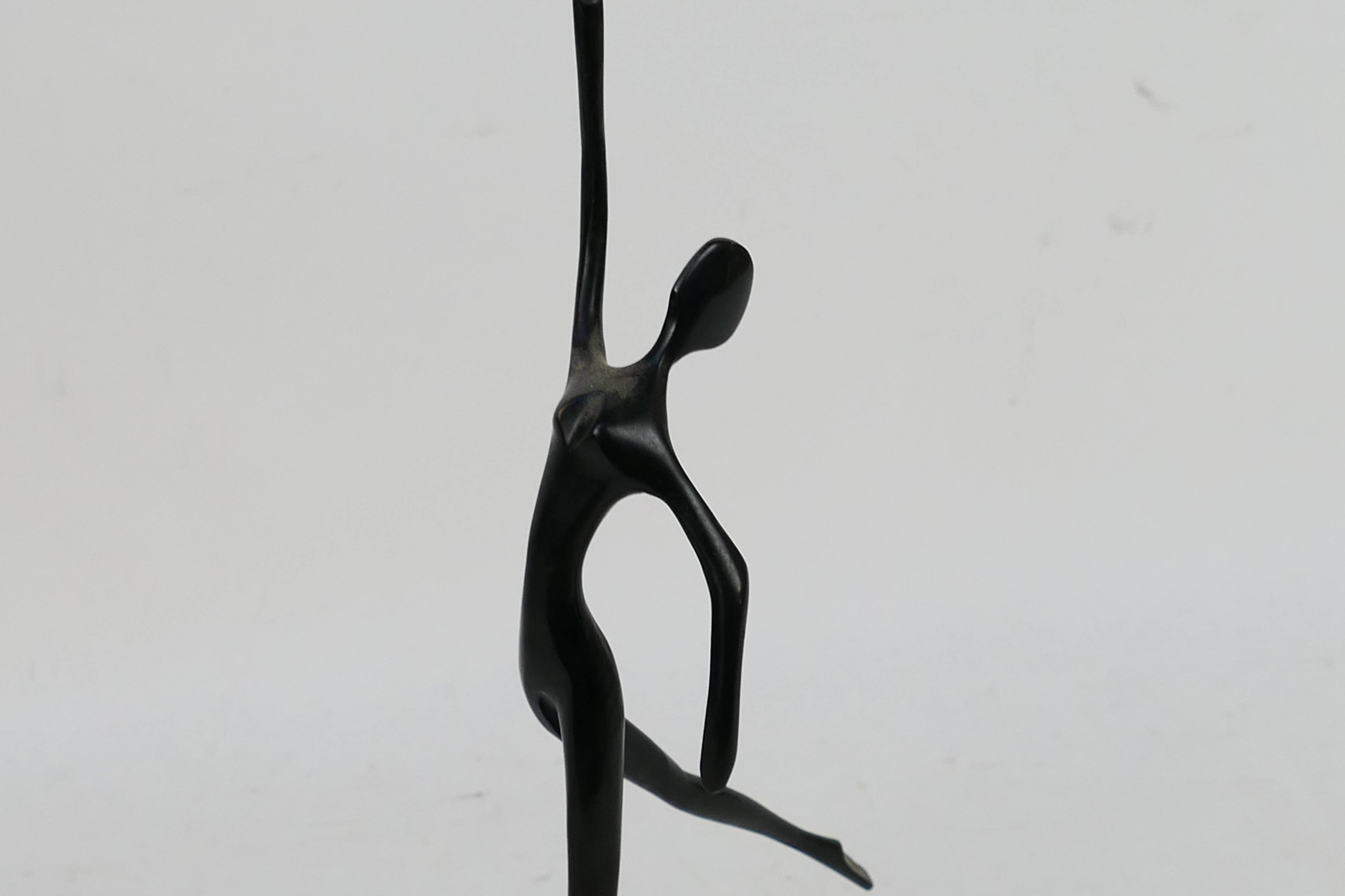 A modern bronze sculpture depicting a stylised, slender female figure 32.5 cm (h). - Image 2 of 4