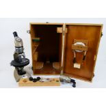 A Vickers Instruments monocular microscope in fitted wooden case with accessories.