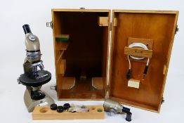 A Vickers Instruments monocular microscope in fitted wooden case with accessories.