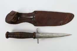 A fighting type knife with turned wooden grip, 13 cm (l) single edge blade,