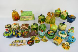 A collection of colourful ceramics to include Marutomo and Maruhon Ware novelty preserve pots,