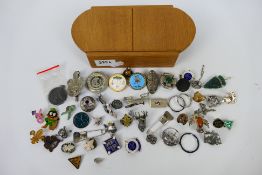 A quantity of pin badges, brooches and similar, some examples stamped Silver.
