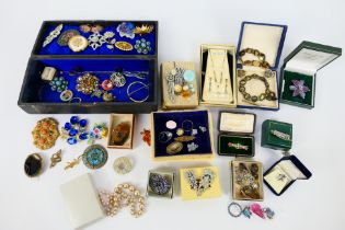 A quantity of costume jewellery to include brooches, earrings, ring and similar.
