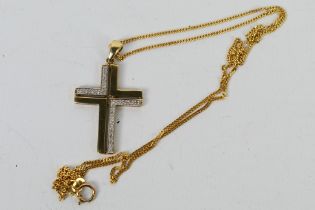 A 9 carat gold modern stone set crucifix pendant with 9 carat gold fine diamond cut curb chain,