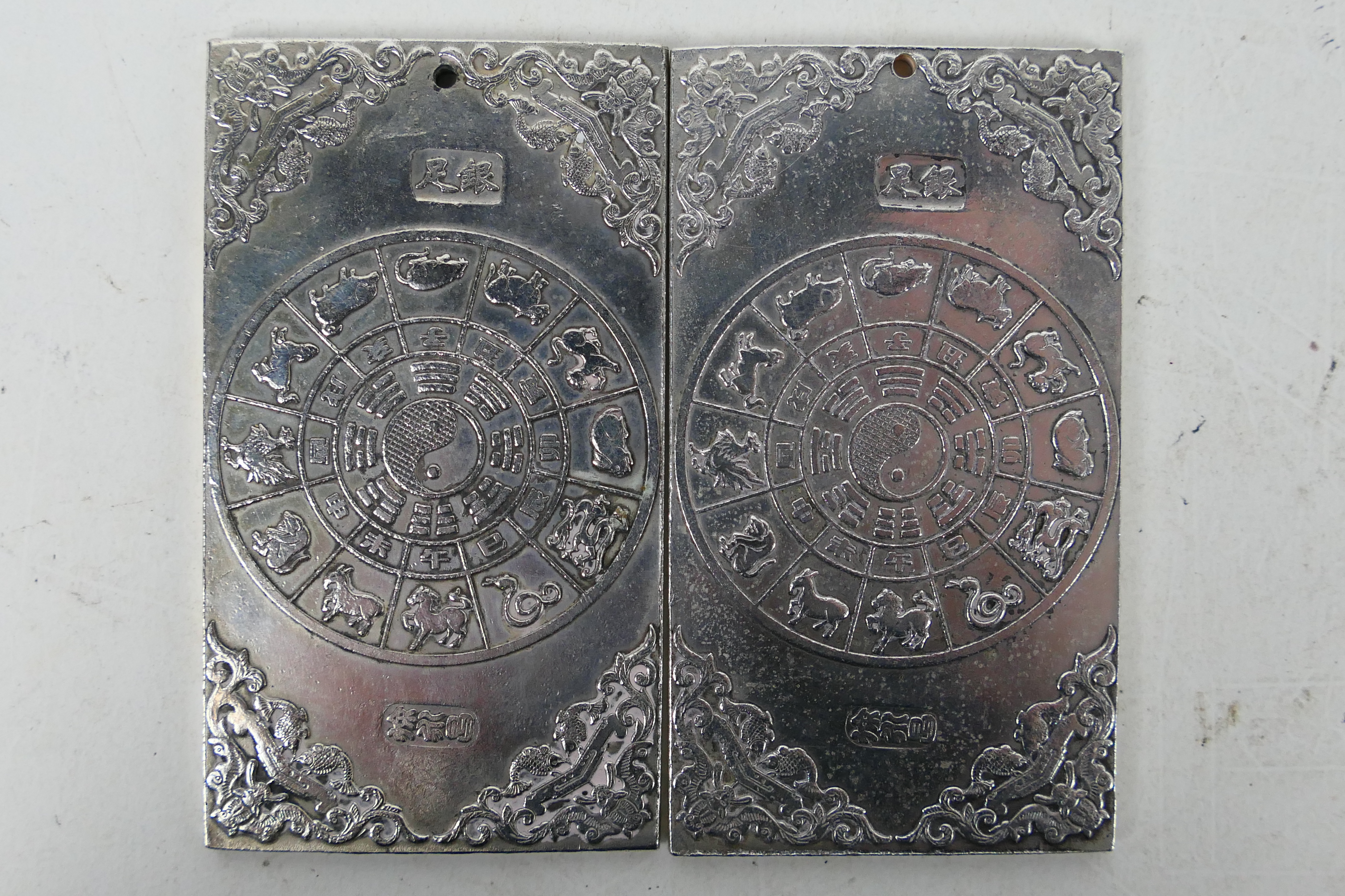 Two Chinese white metal plaques / trade tokens one decorated with a warrior riding a tiger, - Image 4 of 6