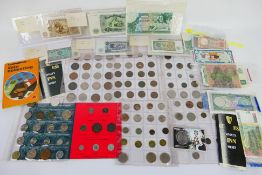 A quantity of UK and foreign coins and banknotes, some silver content noted.