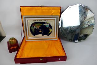 A boxed gemstone terrestrial globe paperweight, a similar wall map, also boxed and a wall mirror.
