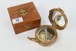 A natural sine brass cased compass with dual spirit level marked Stanley London with natural sine