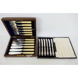 A cased set of six silver handled butter knives and a set of silver mounted fish cutlery. [2].