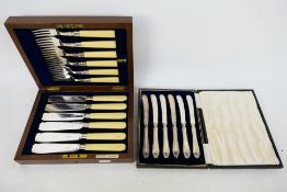 A cased set of six silver handled butter knives and a set of silver mounted fish cutlery. [2].