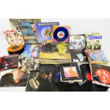 A quantity of 7" and 12" vinyl records to include The Beatles, The Rolling Stones, David Bowie,