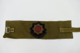 An armband bearing Coldstream Guards insignia.