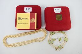 A boxed simulated Pearl and Jade necklace and earring set, and a further string of simulated pearls,