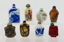 A group of snuff bottles to include glass, ceramic, white metal mounted and other.