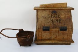 A vintage shoe shine box, 39 cm x 39 cm x 24 cm and a cast iron pot.