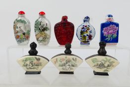 A quantity of snuff bottles to include glass, bone and horn and ceramic examples.