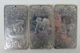 Three Chinese white metal trade tokens / plaques with zodiac decoration to each side,