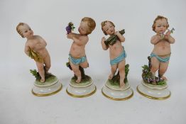 Four capodimonte figures of putti, signed B (Bruno) Merli, approximately 16 cm (h).