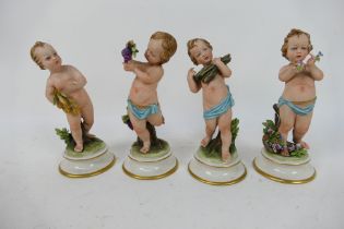 Four capodimonte figures of putti, signed B (Bruno) Merli, approximately 16 cm (h).