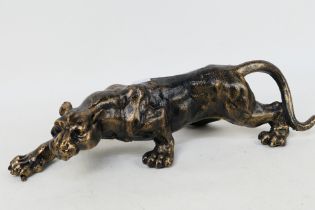 A bronzed cast iron model depicting a panther, approximately 40 cm (l).