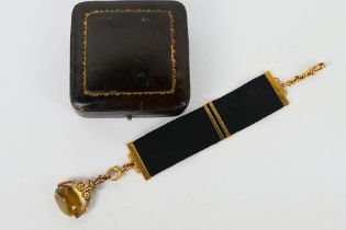 An antique 9 carat gold Citrine swivel watch fob pendant with medal ribbon, cased, approx weight 15.