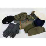 A quantity of military and military style caps, hats and other.