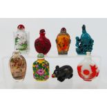 A group of snuff bottles to include glass, ceramic, carved stone and other.