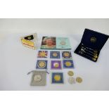 A quantity of commemorative coins and a cased set of Queen Elizabeth II Golden Jubilee spoons.
