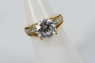 A 14ct yellow gold ring set with white stones, size H+½, approximately 3.4 grams.