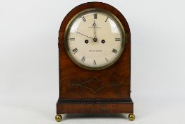 An early 19th century mahogany-cased arch top mantel clock,