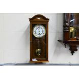 A Comitti Of London wall clock, approximately 58 cm.