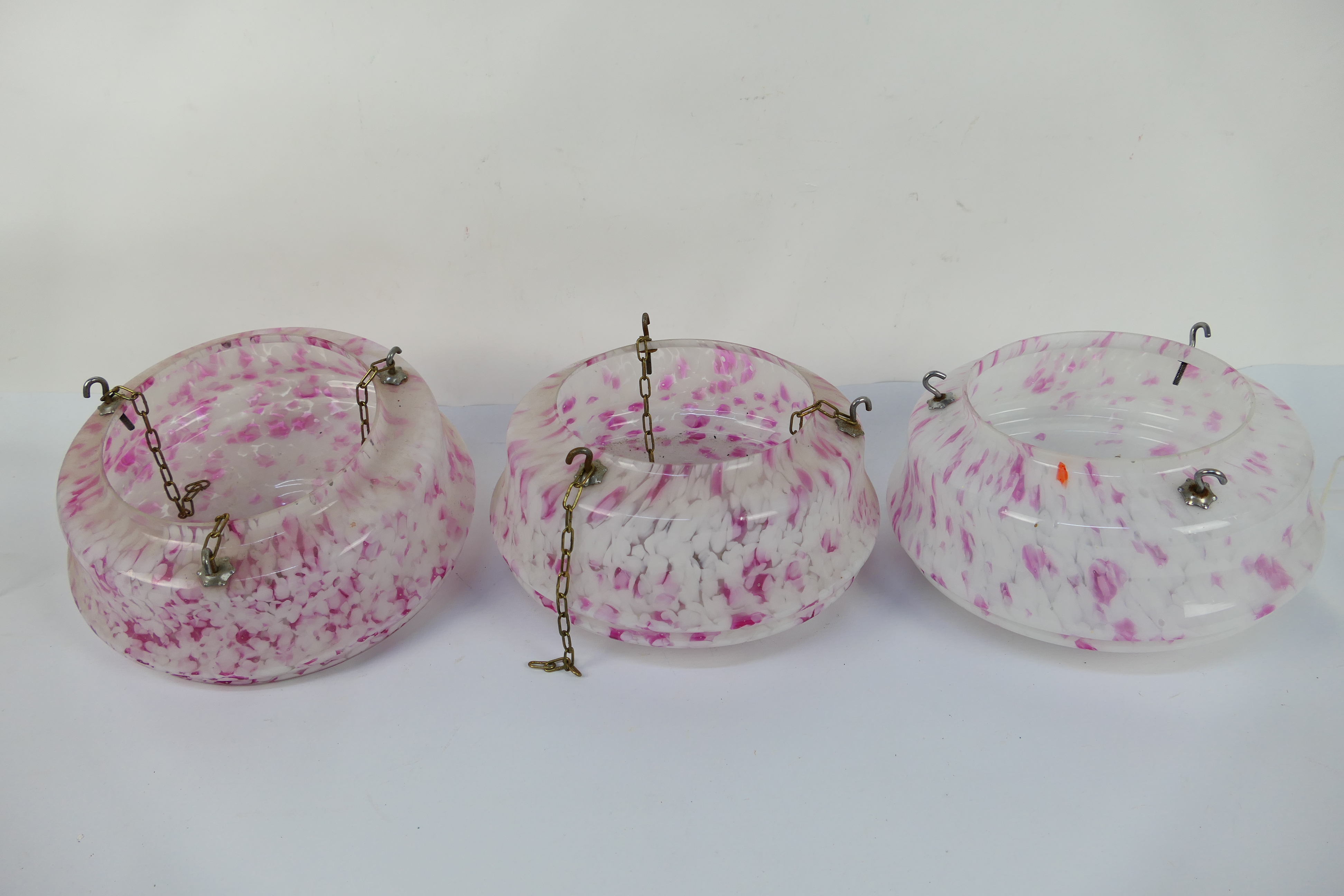 A set of three mid-century marbled glass ceiling lights, approximately 27 cm (d).