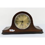 A Napoleons hat mantel clock with key and pendulum.