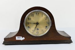 A Napoleons hat mantel clock with key and pendulum.