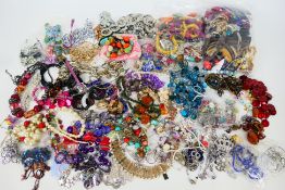 A collection of various costume jewellery, predominantly necklaces.
