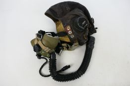 An RAF C type brown leather flying helmet with earphones and oxygen mask.