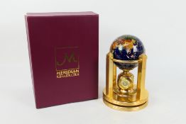 A boxed Meridian Collection desk top gemstone terrestrial globe with built in clock,