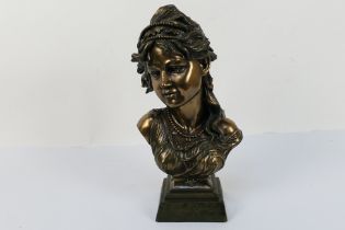 A bronzed bust depicting a female, signed Crosa 2001, approximately 32 cm (h).